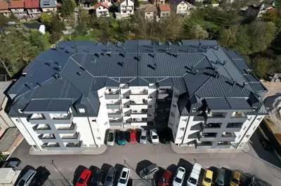 an aerial view of a building with cars parked in a parking lot at Lux Sara Apartments in Visoko