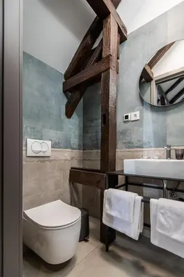 a bathroom with a white toilet and a sink at LANTerna Boutique Hotel in Srbac