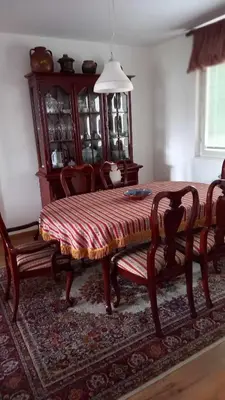 a dining room with a wooden table and chairs at Stan u Zenici in Zenica
