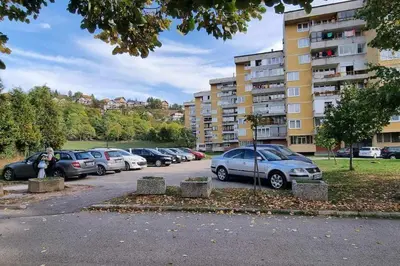 a row of parked cars in a parking lot at Stan u Zenici in Zenica