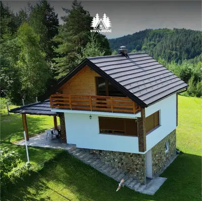 a small house with a roof on a field at Vikendica Stevanovic in Doboj