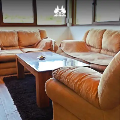 a living room with couches and a coffee table at Vikendica Stevanovic in Doboj