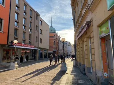a group of people walking down a city street at Zeus apartman in Banja Luka
