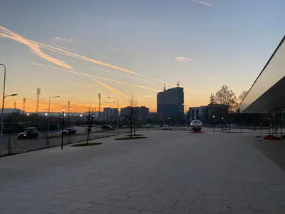 a view of a city at sunset with buildings at Zeus apartman in Banja Luka