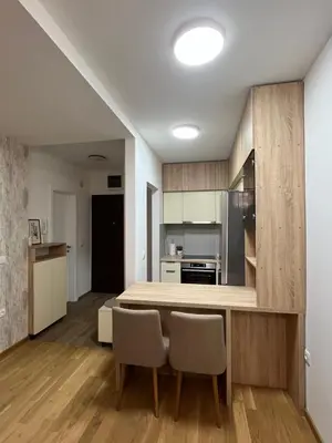 a kitchen with a table and chairs in a room at Apartment Romano Banja Luka in Banja Luka