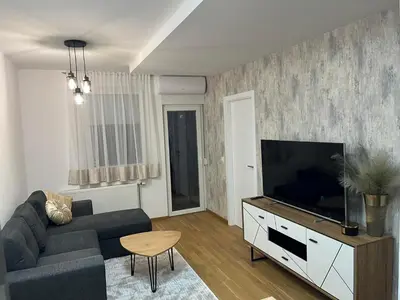 a living room with a couch and a flat screen tv at Apartment Romano Banja Luka in Banja Luka