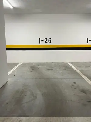 an empty parking garage with a yellow and white wall at Apartment Romano Banja Luka in Banja Luka