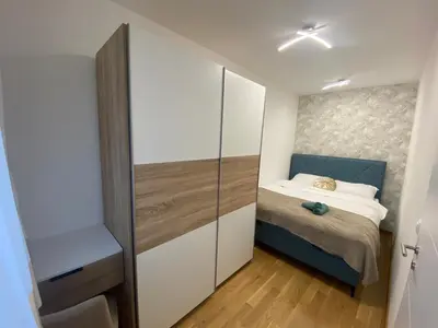 a small bedroom with a bed and a closet at Apartment Romano Banja Luka in Banja Luka