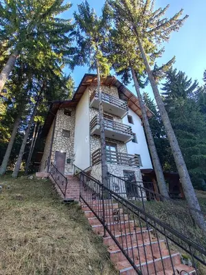a house with stairs leading up to it at Apartments Planinski raj in Travnik