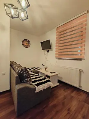 a living room with a couch and a table at Apartments Planinski raj in Travnik