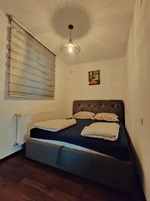 a bedroom with a bed in a room with a ceiling at Apartments Planinski raj in Travnik