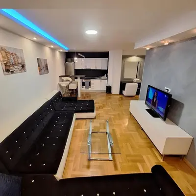 a living room with a large couch and a tv at Luks apartment in Banja Luka