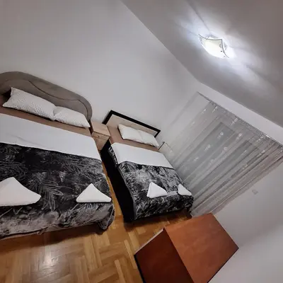 two beds in a small room with aperate at Luks apartment in Banja Luka
