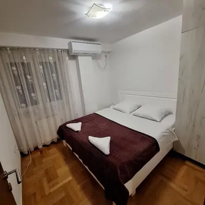 a bedroom with a bed with two pillows on it at Luks apartment in Banja Luka