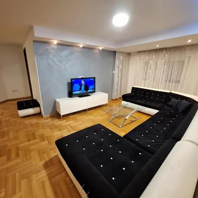 a living room with a couch and a flat screen tv at Luks apartment in Banja Luka