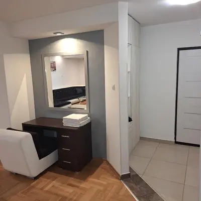 a bathroom with a desk and a mirror at Luks apartment in Banja Luka