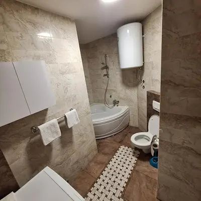 a bathroom with a toilet and a tub and a sink at Luks apartment in Banja Luka