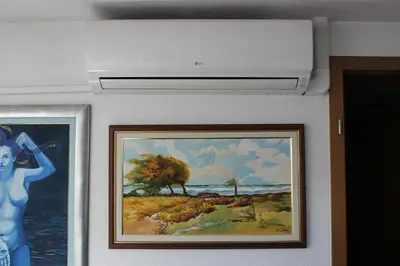 a bathroom with two paintings on the wall at Apartman Bony M in Kiseljak