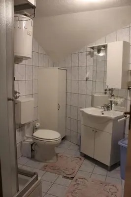 a bathroom with a toilet and a sink at Apartman Bony M in Kiseljak