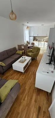 a living room with a couch and a table at SunShine Apartman CityBlock in Banja Luka