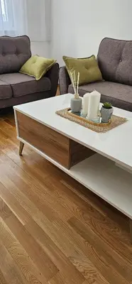a coffee table in a living room with a couch at SunShine Apartman CityBlock in Banja Luka