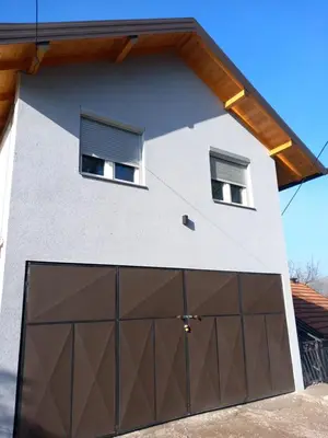 a garage door in front of a house at Apartment B&E in Tuzla