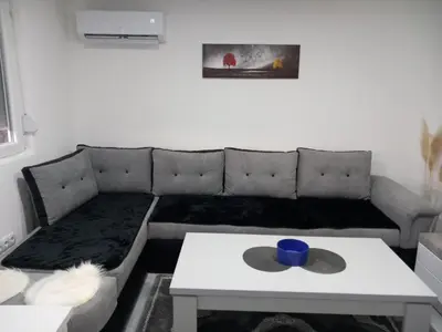 a living room with a couch and a table at Apartment B&E in Tuzla