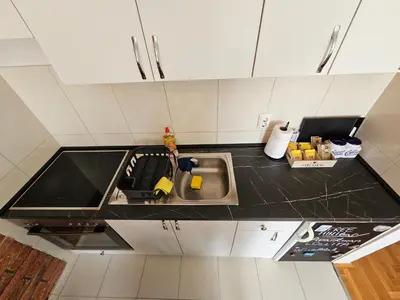 a kitchen with a sink and a counter top at Apartman Lollita in Banja Luka