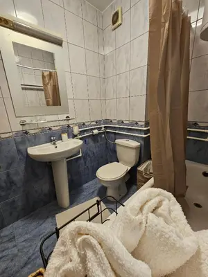 a bathroom with a toilet and a sink and a tub at Apartman Lollita in Banja Luka
