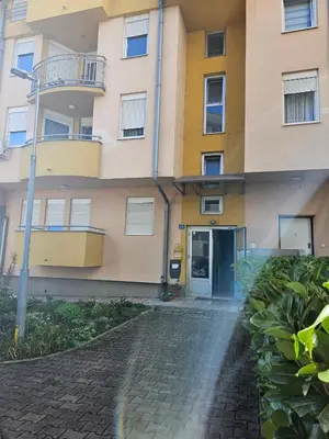 an apartment building with a door and a brick driveway at Apartman Lollita in Banja Luka