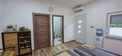 a living room with a couch and a window at Riverstone Retreat Studio in Jajce