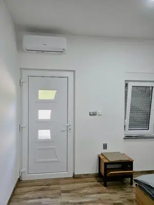 a white door in a room with a table at Riverstone Retreat Studio in Jajce