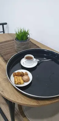 a black tray with a plate of food on a table at Riverstone Retreat Studio in Jajce
