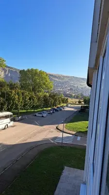 a view of a street with cars parked in a parking lot at Apartman Greta in Livno