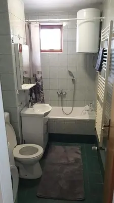 a bathroom with a toilet and a tub and a shower at Apartman Greta in Livno