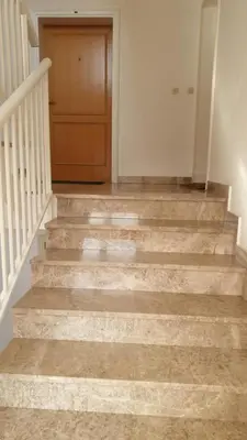 a staircase with a wooden door in a house at Apartman Greta in Livno