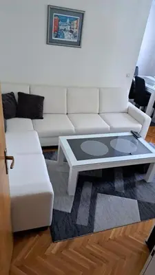 a living room with a white couch and a coffee table at Apartman Greta in Livno