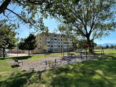 a playground in a park with a large tree at Apartman Greta in Livno