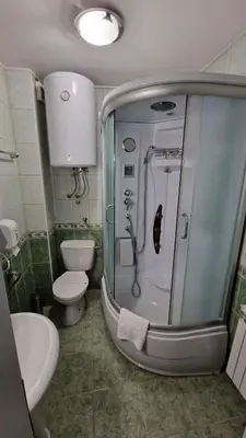 a bathroom with a shower and a toilet and a sink at Olimpus Apartmani BD Banjaluka in Banja Luka