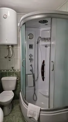 a bathroom with a shower and a toilet at Olimpus Apartmani BD Banjaluka in Banja Luka