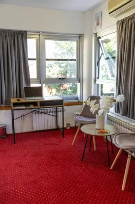 a room with a desk and a laptop on a table at Olimpus Apartmani BD Banjaluka in Banja Luka