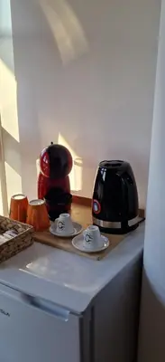 a kitchen counter with a toaster and plates on it at Olimpus Apartmani BD Banjaluka in Banja Luka