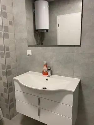 a bathroom with a white sink and a mirror at ,,Azra,, Apartment in Bihać
