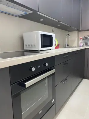 a kitchen with a microwave and a stove top oven at ,,Azra,, Apartment in Bihać