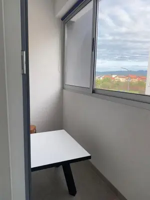 a white bench in a room with a window at ,,Azra,, Apartment in Bihać