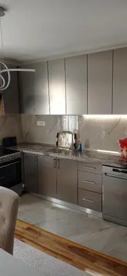 a kitchen with stainless steel cabinets and a stove at Topli dom in Banja Luka