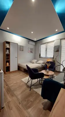 a living room with a bed and a couch at Apartman Jereza Prijedor in Prijedor