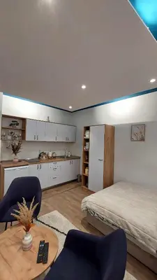 a bedroom with a bed and a table and chairs at Apartman Jereza Prijedor in Prijedor