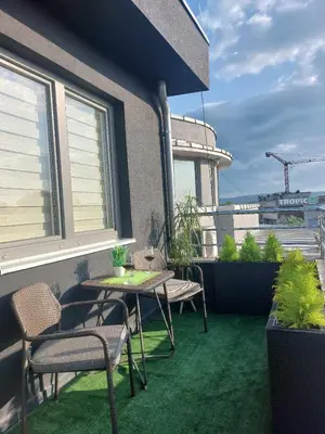 a patio with a table and chairs on a balcony at Apartman Jereza Prijedor in Prijedor