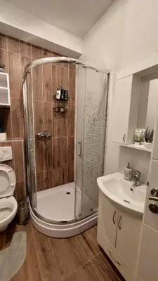 a bathroom with a shower and a toilet and a sink at Apartman Jereza Prijedor in Prijedor